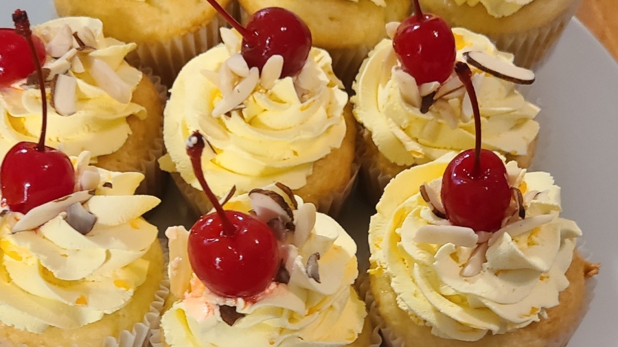 Mai-Tai flavored cupcakes topped with slivered almonds.