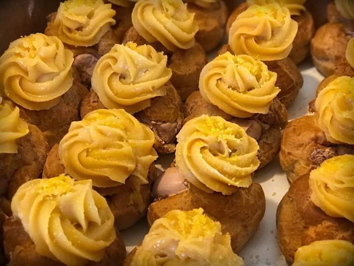 A cream puff stuffed with chocolate mousse and topped with a chantilly icing.