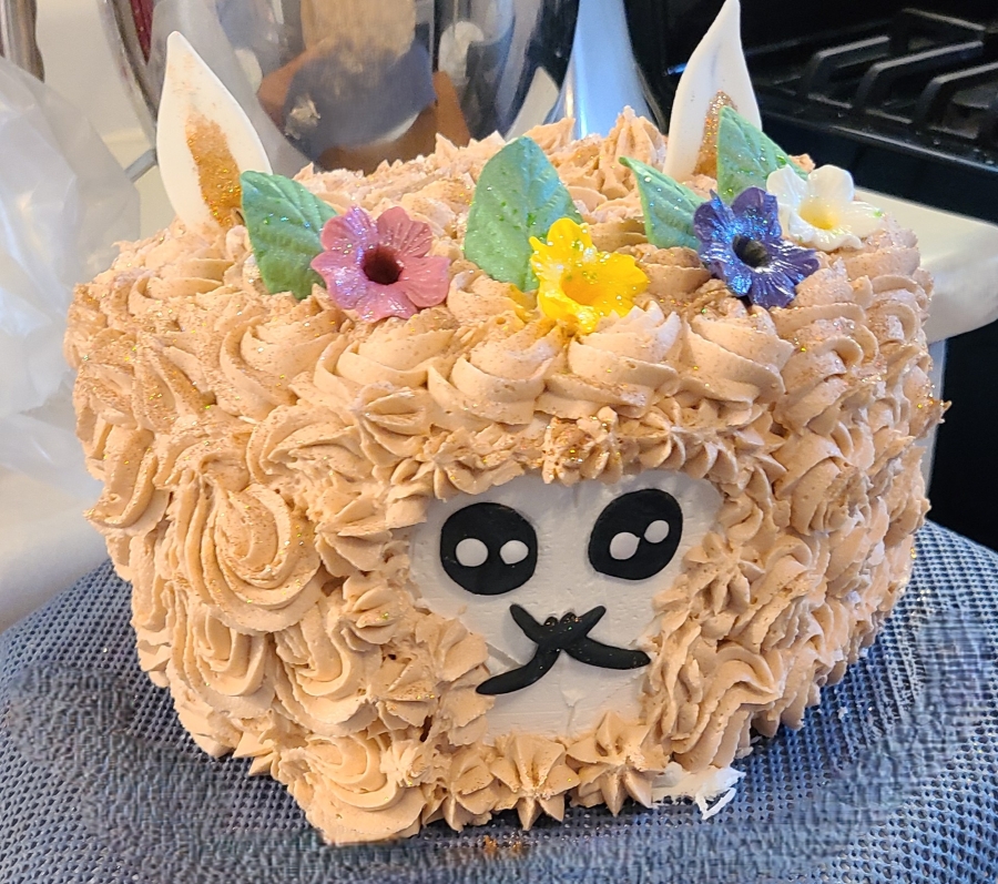 A festive birthday cake decorated as a llama.