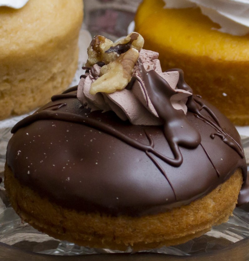 A triple chocolate cupcake topped with walnut.